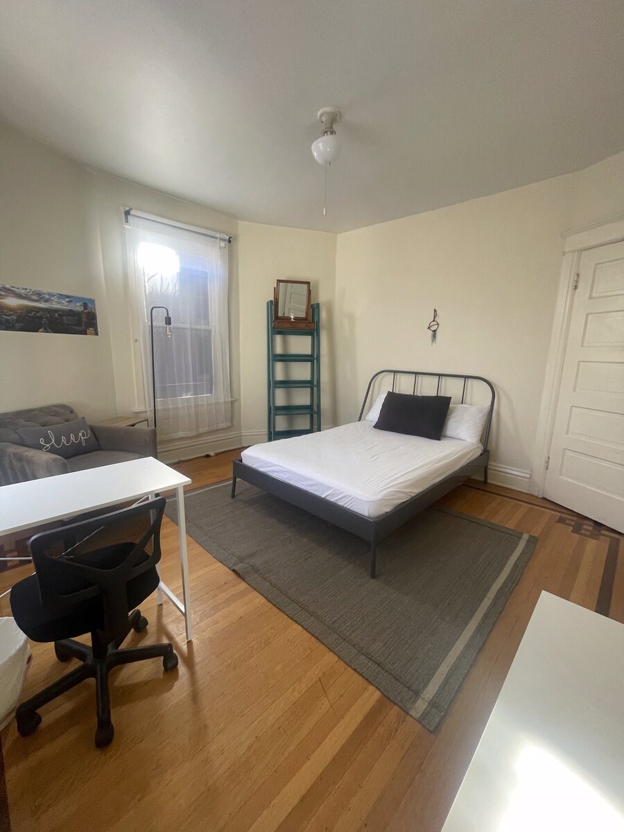 Garden suite — the largest room in the house, with a queen bed, desk and bright east and south windows